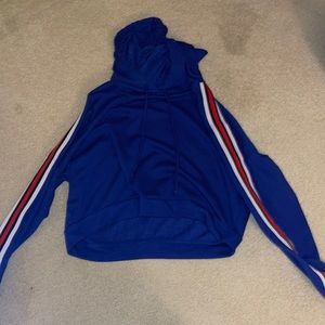 Blue crew neck size M with red and white stripes on both sleeves